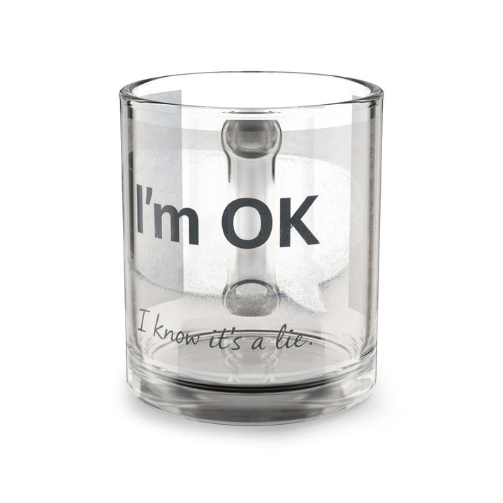 Clear glass mug with text 'I'm OK, I know it's a lie' on a white background