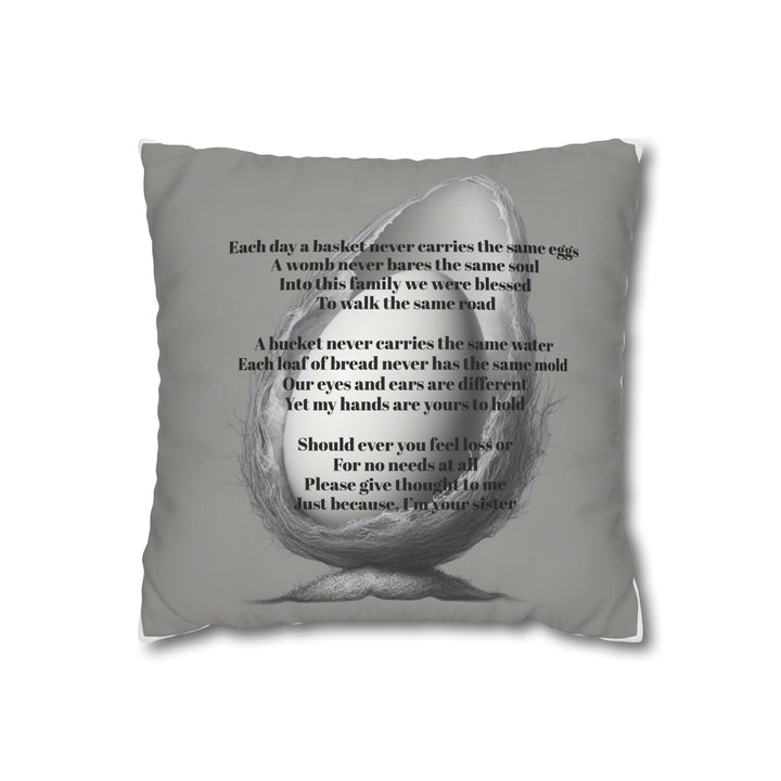 Gray pillow with text and a graphic of a nest holding an egg on a white background with an Olga Foreign poem